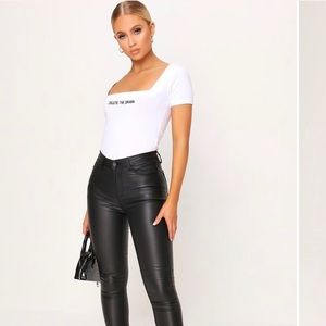 Black Coated button front skinny jeans with zip